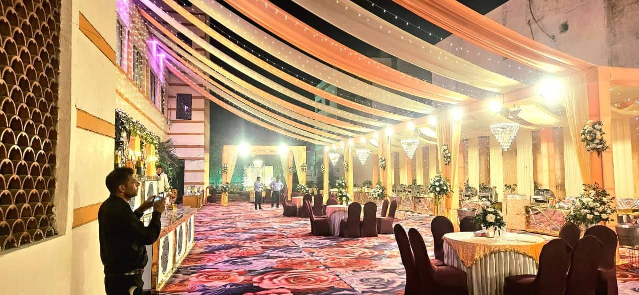 The covered outdoor venue at night, lit with string lights above a seated function