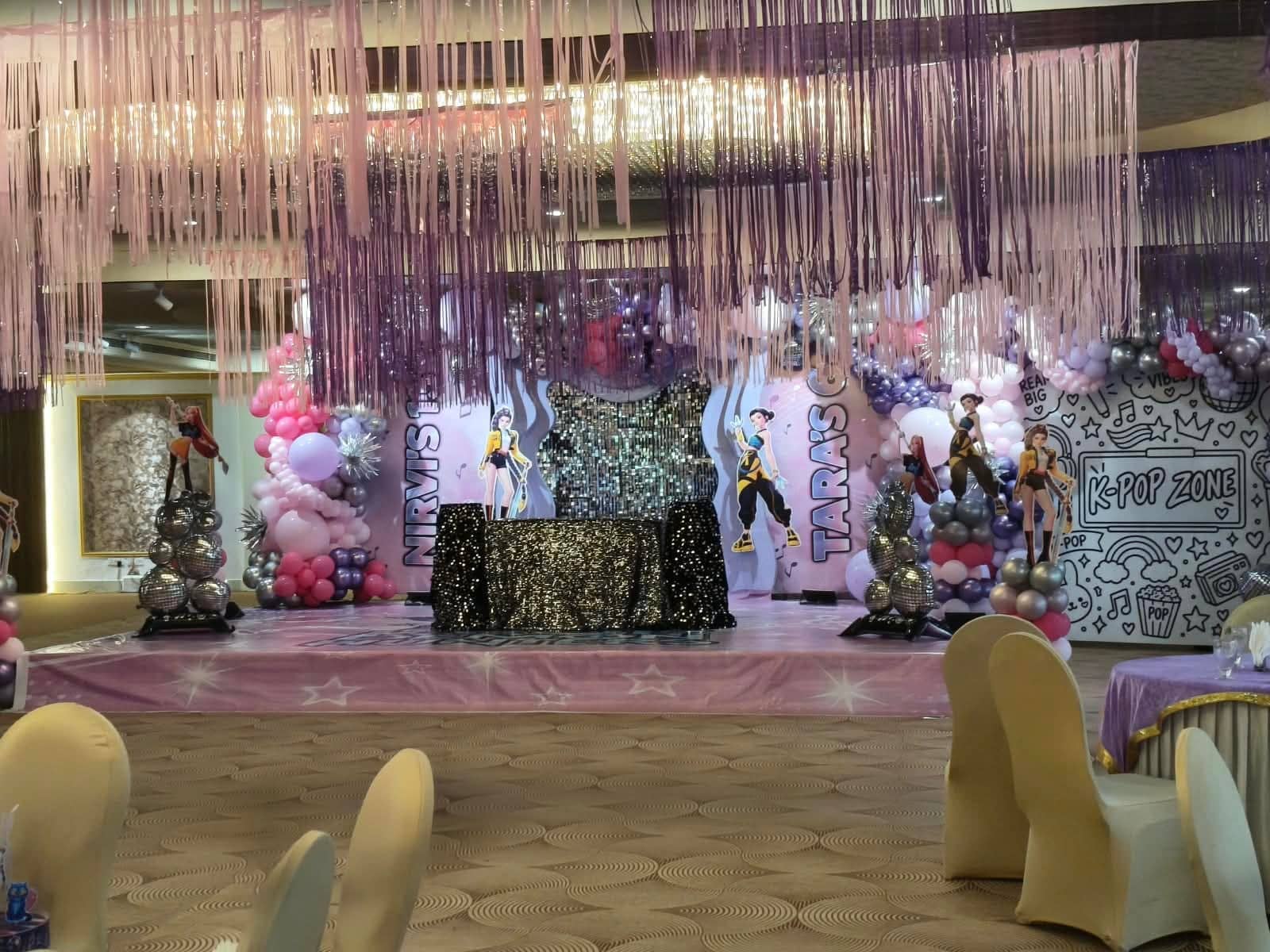 An outdoor function in progress with guests at draped tables and a live counter service area