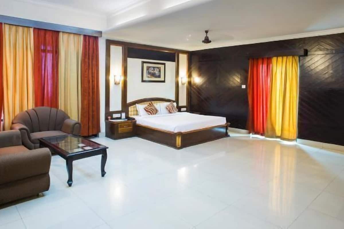 A room with a bed and a separate seating area