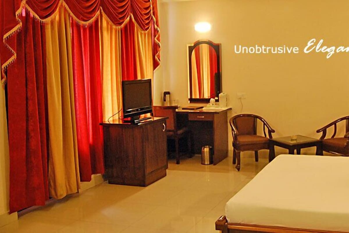 A double-bedded guest room, photographed from the doorway